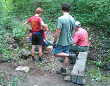 Scout Troop Members Working On Bridge