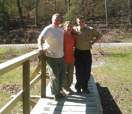 Micah Cravens and parents on refurbished Oak Hickory Trail Bridge